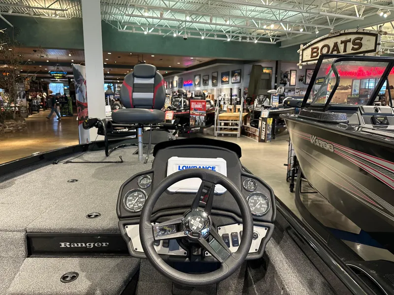 Slide: The Image of 2024 Ranger RT188P boat interior with steering wheel and display in showroom. - 2
