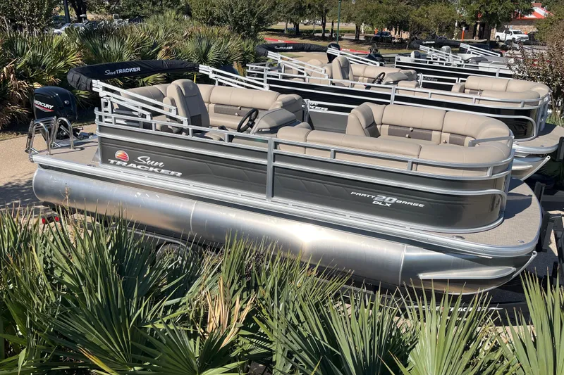 Slide: The Image of 2024 Sun Tracker Party Barge 20 DLX pontoon boat displayed outdoors. - 55