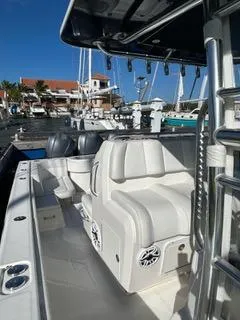 Slide: The Image of 2017 Invincible 39 Open Fisherman boat docked at marina, featuring spacious seating and modern design. - 11