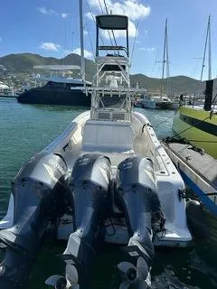 Slide: The Image of 2017 Invincible 39 Open Fisherman boat with triple outboard engines docked at marina. - 17