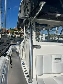 Slide: The Image of 2017 Invincible 39 Open Fisherman boat docked at marina, showcasing sleek design and spacious deck. - 8