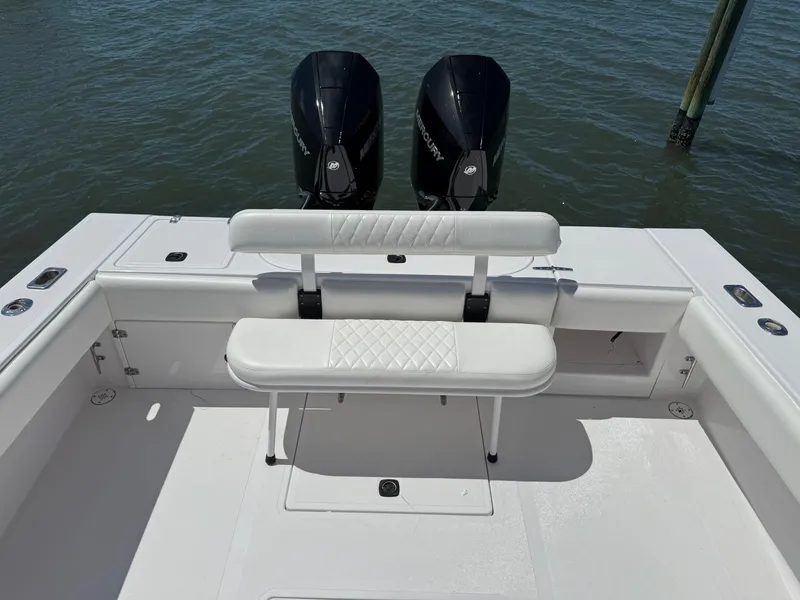 Slide: The Image of 1998 Venture Center Console boat with dual Mercury engines, white seating, and spacious deck. - 10