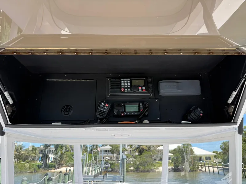 Slide: The Image of 1998 Venture Center Console boat dashboard with communication equipment and scenic marina view. - 7