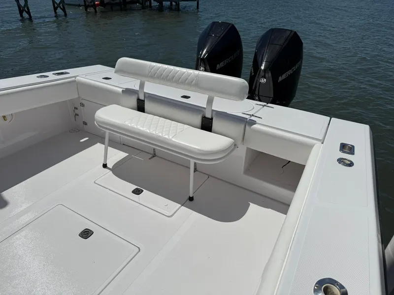 Slide: The Image of 1998 Venture Center Console boat with dual Mercury engines, featuring white seating and spacious deck. - 8