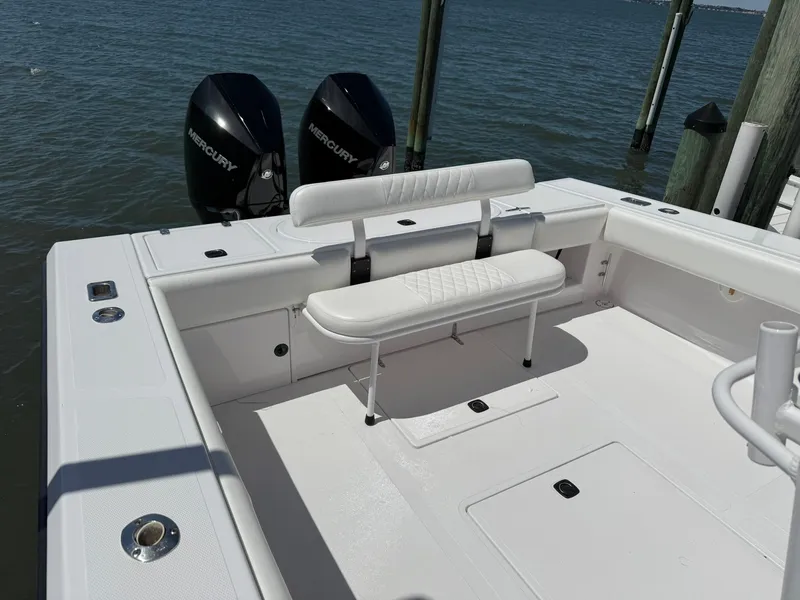 Slide: The Image of 1998 Venture Center Console boat with dual Mercury engines, white seating, and spacious deck. - 9