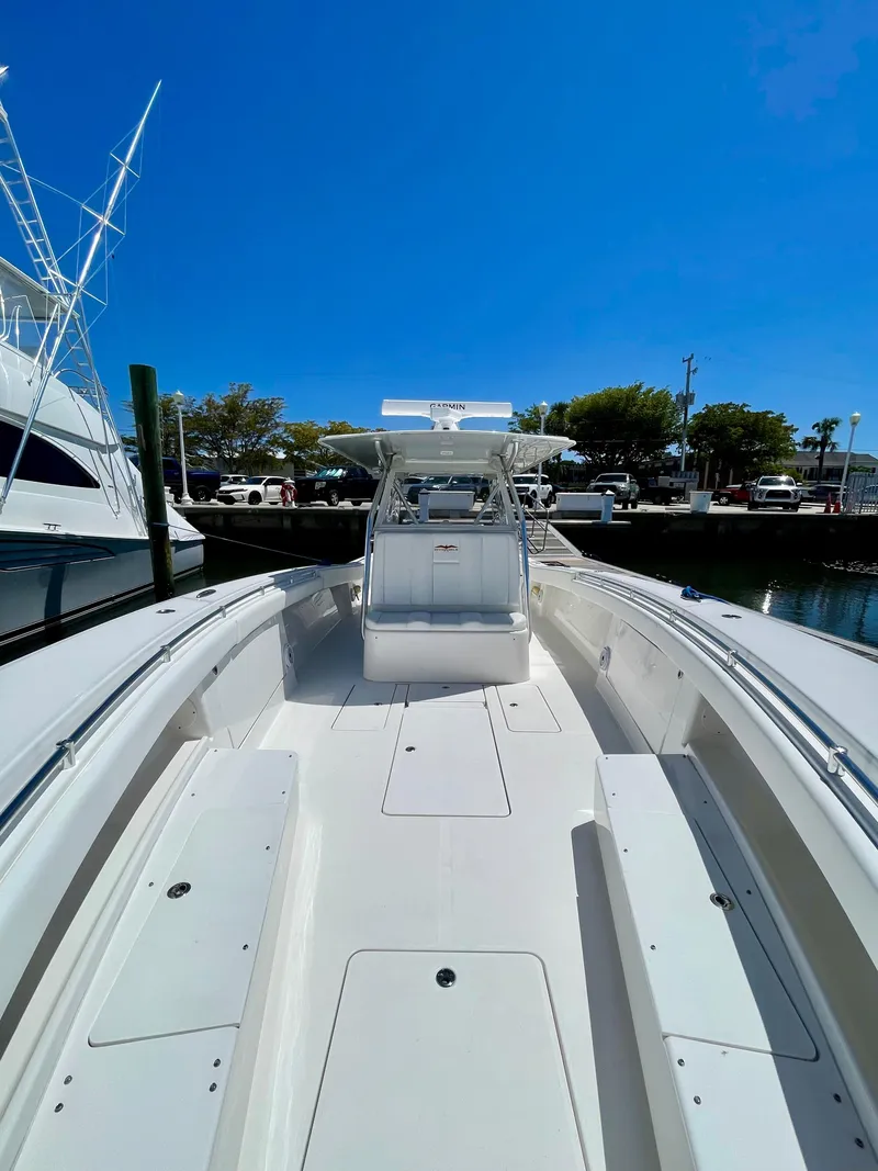 Slide: The Image of 2014 Invincible 42 Open Fisherman boat docked under clear blue sky. - 10