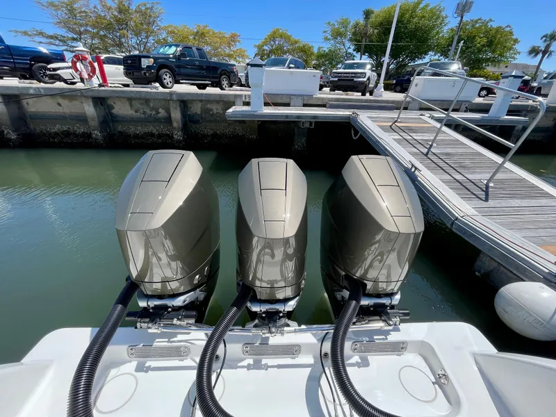 Slide: The Image of Triple outboard engines on a 2014 Invincible 42 Open Fisherman at a dock. - 17
