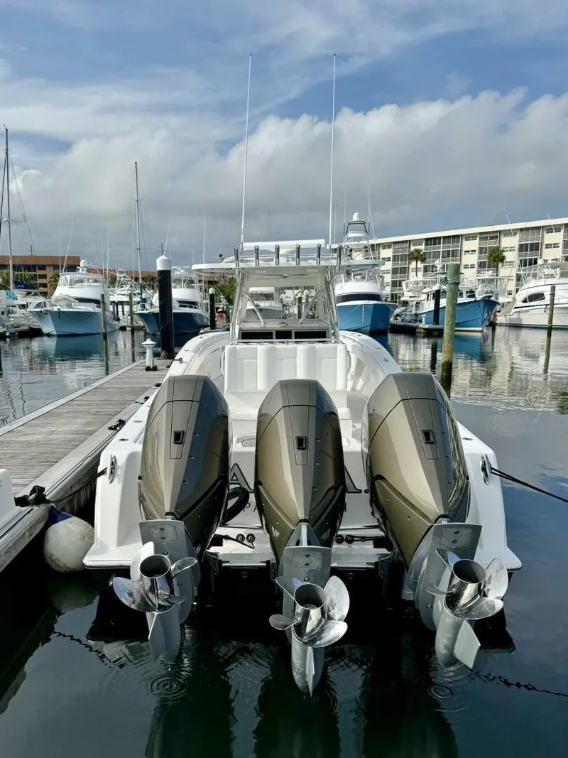 Slide: The Image of 2014 Invincible Open Fisherman boat docked with triple outboard engines. - 19