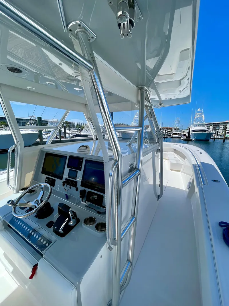 Slide: The Image of 2014 Invincible 42 Open Fisherman boat with sleek design and advanced navigation controls. - 2