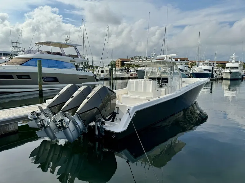 Slide: The Image of 2014 Invincible Open Fisherman boat docked in marina with triple outboard engines. - 21