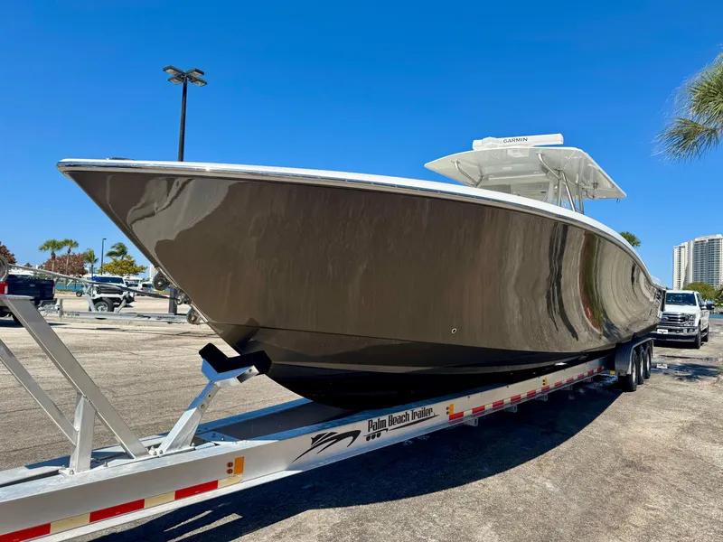 Slide: The Image of 2014 Invincible 42 Open Fisherman boat on trailer under clear blue sky. - 22
