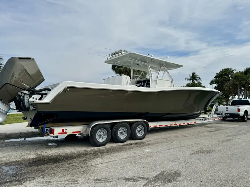 Slide: The Image of 2014 Invincible Open Fisherman boat on trailer, parked outdoors. - 23