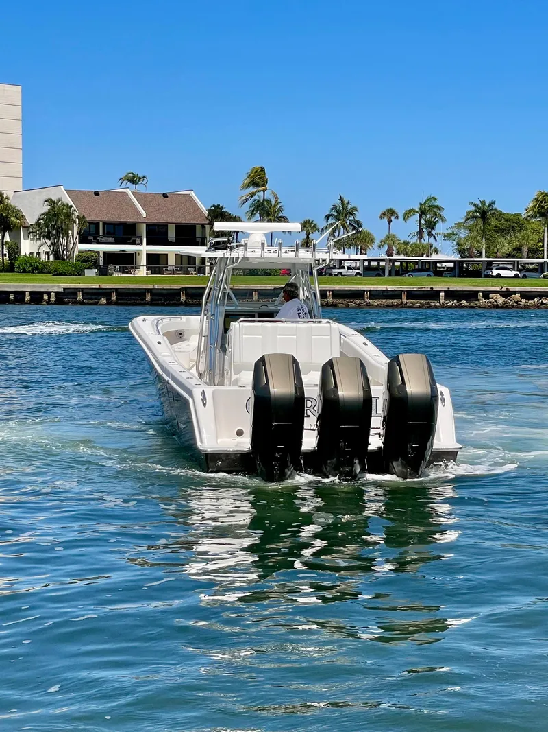 Slide: The Image of 2014 Invincible 42 Open Fisherman boat with triple engines on a sunny day. - 27