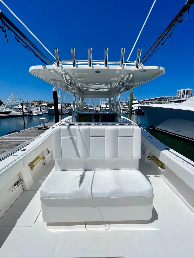 Slide: The Image of 2014 Invincible 42 Open Fisherman boat docked at marina under clear blue sky. - 4