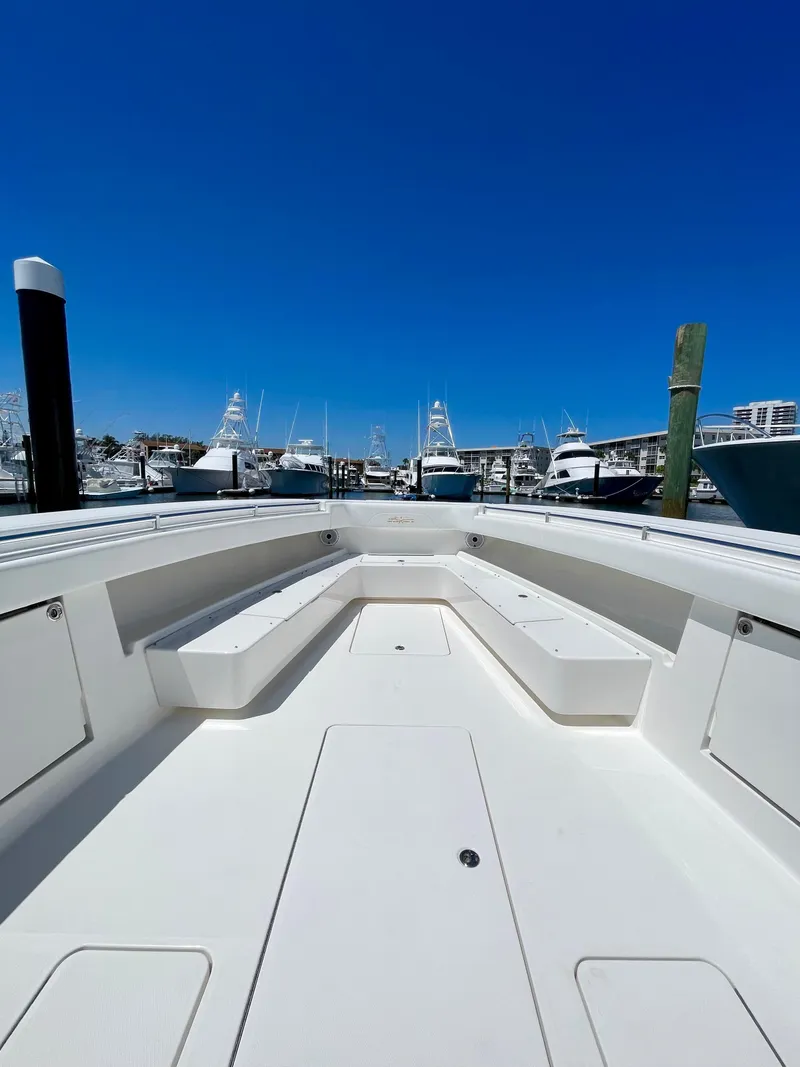 Slide: The Image of 2014 Invincible 42 Open Fisherman boat docked at a marina under clear blue skies. - 7