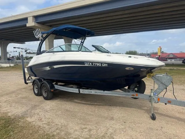 Slide: The Image of 2014 Sea Ray 220 SD Outboard boat on trailer under bridge. - 0