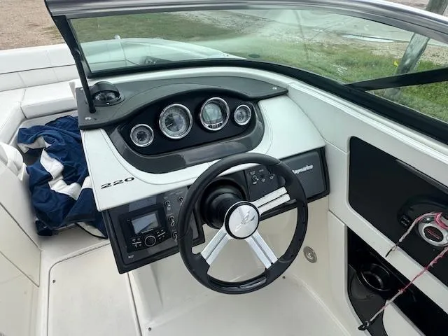 Slide: The Image of 2014 Sea Ray 220 SD Outboard boat dashboard with steering wheel and gauges. - 10
