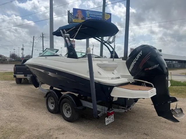 Slide: The Image of 2014 Sea Ray 220 SD Outboard boat on trailer with Mercury engine, parked outdoors. - 3