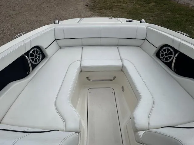 Slide: The Image of 2014 Sea Ray 220 SD Outboard boat interior with white seating and speakers. - 9