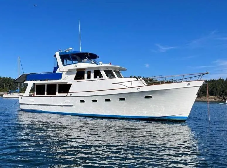 The Image of 1980 Ocean Alexander 50 MK1 yacht on calm water under clear blue sky. - 0