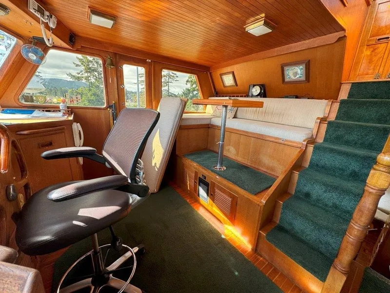 Slide: The Image of Interior of 1980 Ocean Alexander 50 MK1 yacht with wood paneling and seating area. - 16
