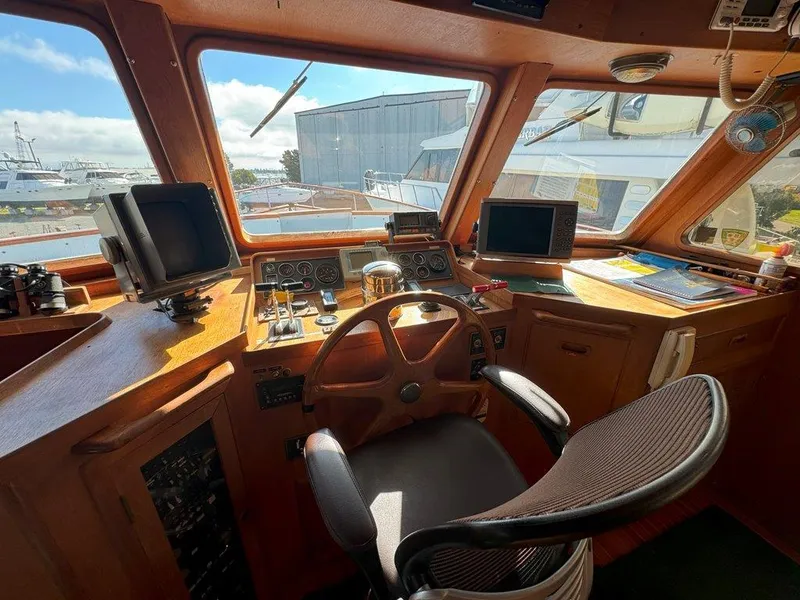 Slide: The Image of Cockpit of 1980 Ocean Alexander 50 MK1 yacht with steering wheel and navigation equipment. - 17