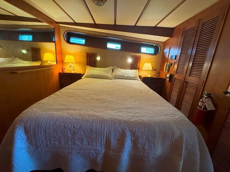 Slide: The Image of Cozy bedroom in 1980 Ocean Alexander 50 MK1 yacht with wood paneling and ambient lighting. - 27