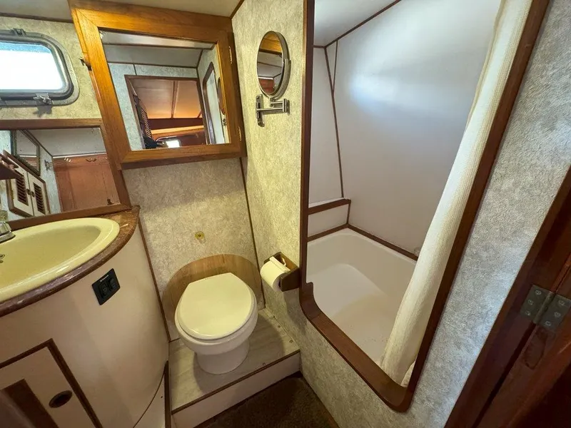 Slide: The Image of 1980 Ocean Alexander 50 MK1 yacht bathroom with toilet, sink, and shower. - 28