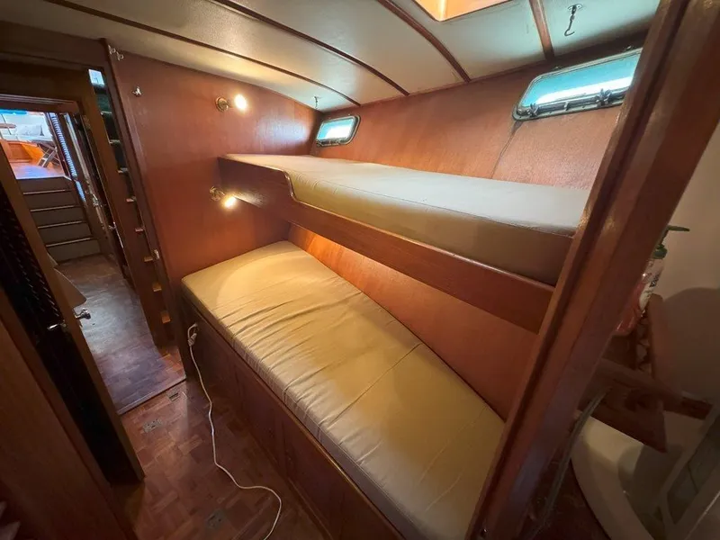 Slide: The Image of Interior of 1980 Ocean Alexander 50 MK1 yacht with wooden bunk beds and cozy lighting. - 33