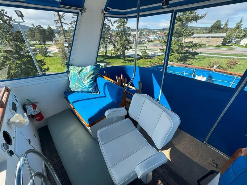 Slide: The Image of Interior view of 1980 Ocean Alexander 50 MK1 yacht with blue seating and scenic windows. - 40