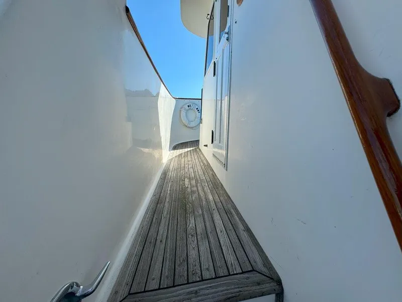 Slide: The Image of Narrow deck passage on 1980 Ocean Alexander 50 MK1 yacht with wooden flooring. - 43