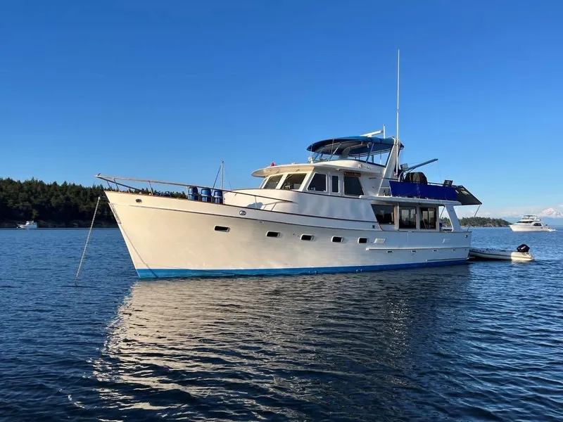 Slide: The Image of 1980 Ocean Alexander 50 MK1 yacht anchored on calm water under clear blue sky. - 53