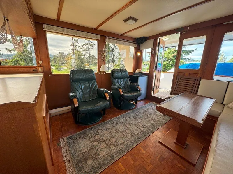 Slide: The Image of Interior of 1980 Ocean Alexander 50 MK1 yacht with leather chairs and wooden table. - 6