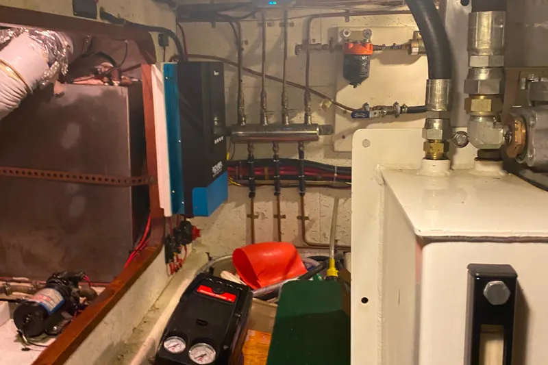 Slide: The Image of Engine room of 1980 Ocean Alexander 50 MK1 yacht with mechanical components. - 63