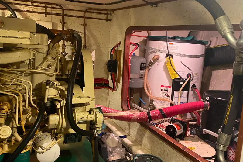 Slide: The Image of Engine room of 1980 Ocean Alexander 50 MK1 yacht with visible machinery and piping. - 64