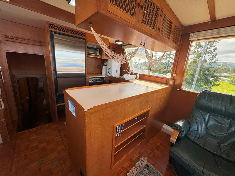 Slide: The Image of Interior of 1980 Ocean Alexander 50 MK1 yacht with wooden cabinetry and large windows. - 7
