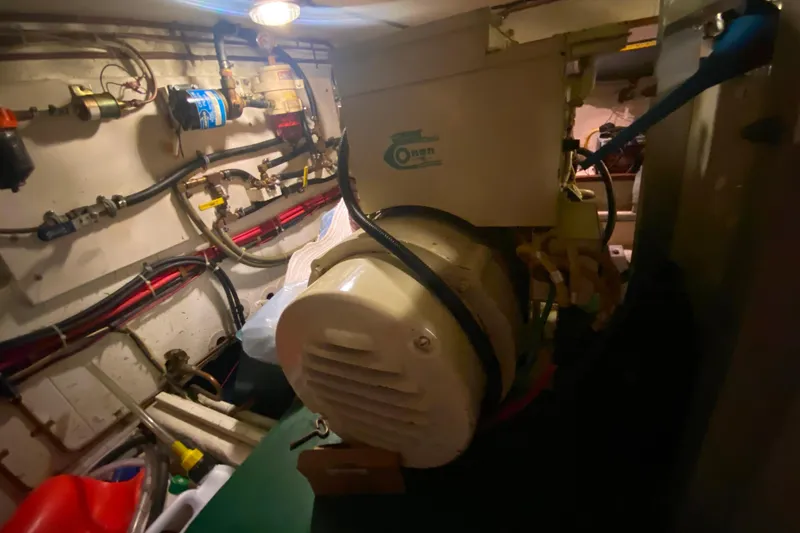 Slide: The Image of Engine room of 1980 Ocean Alexander 50 MK1 yacht with visible machinery and wiring. - 80