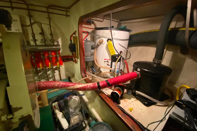 Slide: The Image of Engine room of 1980 Ocean Alexander 50 MK1 with plumbing and equipment. - 81