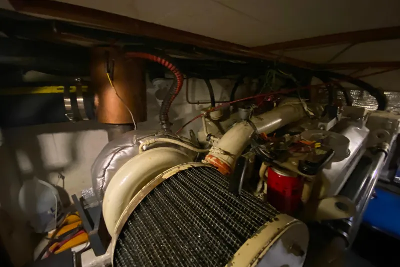 Slide: The Image of Engine room of 1980 Ocean Alexander 50 MK1 yacht, showcasing mechanical components. - 83