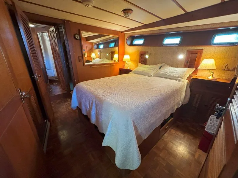 Slide: The Image of Cozy bedroom in 1980 Ocean Alexander 50 MK1 yacht with wood paneling and ambient lighting. - 26