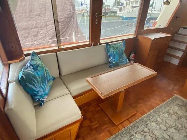 Slide: The Image of Interior of 1980 Ocean Alexander 50 MK1 yacht with cozy seating and wooden table. - 3