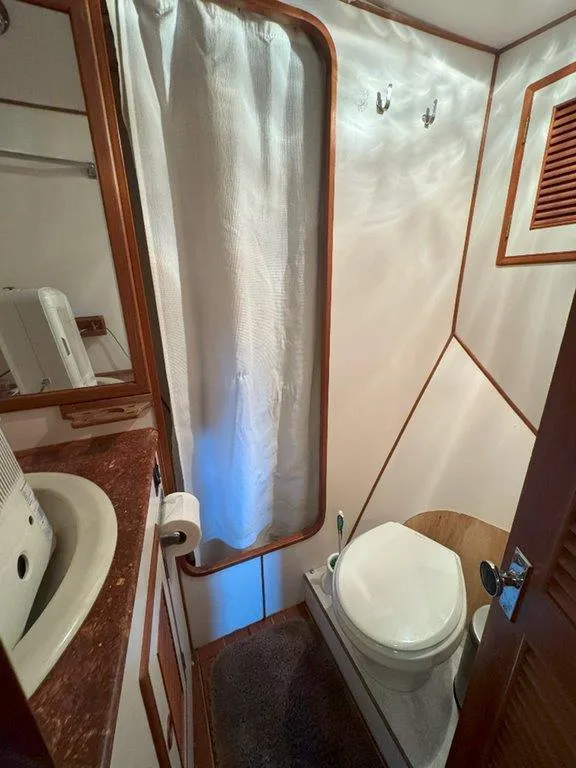 Slide: The Image of Ocean Alexander 50 MK1 1980 yacht bathroom with shower, sink, and toilet. - 34