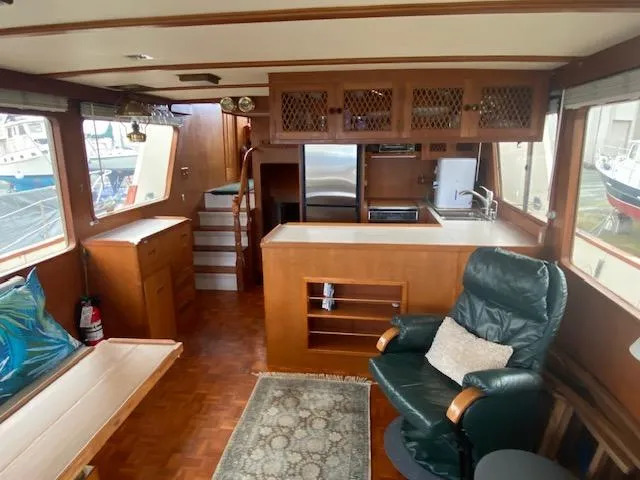 Slide: The Image of Interior of 1980 Ocean Alexander 50 MK1 yacht with wood finishes and comfortable seating. - 4