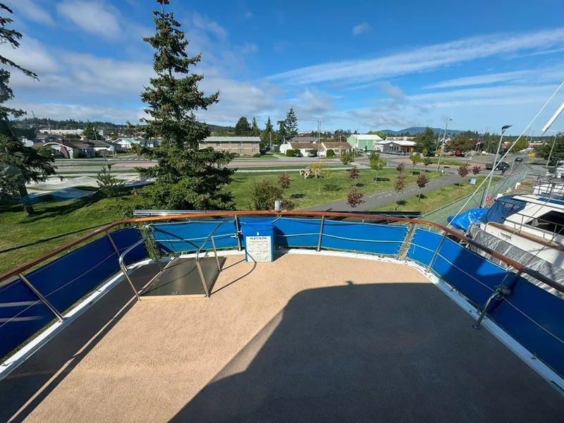 Slide: The Image of Ocean Alexander 50 MK1 yacht deck, 1980 model, with blue railings and scenic marina view. - 41