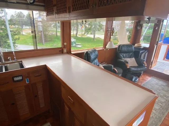 Slide: The Image of Interior of 1980 Ocean Alexander 50 MK1 yacht with wooden cabinetry and seating area. - 5