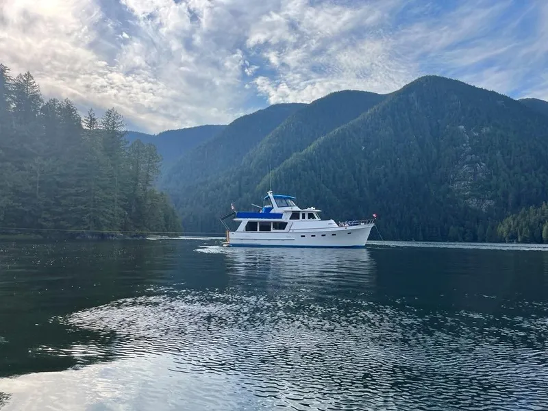 Slide: The Image of Ocean Alexander 50 MK1 yacht cruising in a serene mountain lake, 1980 model. - 54