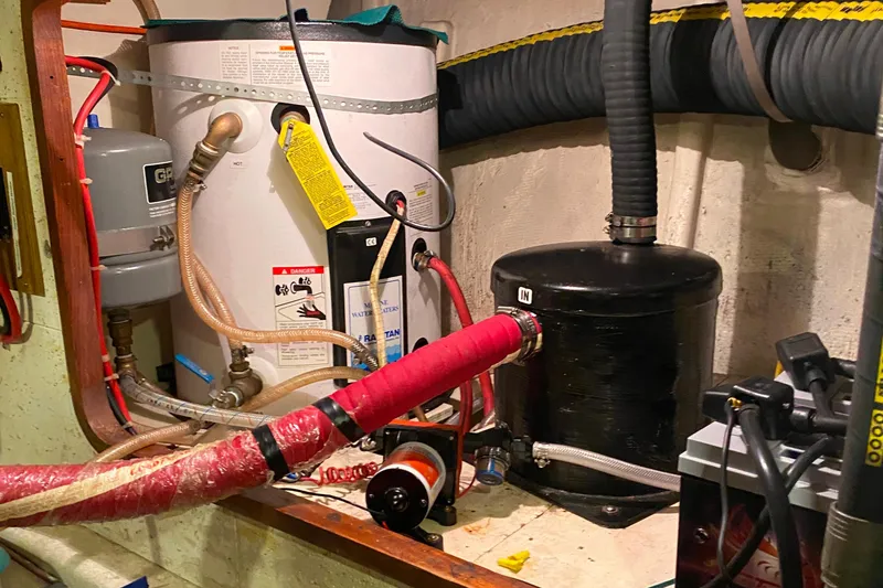 Slide: The Image of Engine room of 1980 Ocean Alexander 50 MK1 with water heater and plumbing components. - 67