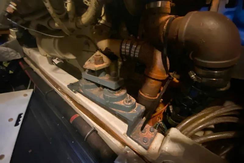 Slide: The Image of Engine compartment of 1980 Ocean Alexander 50 MK1 yacht, showing mechanical components and piping. - 74