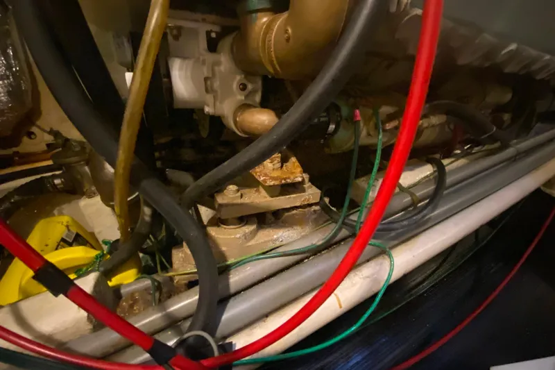 Slide: The Image of Engine compartment of 1980 Ocean Alexander 50 MK1 with visible hoses and components. - 75