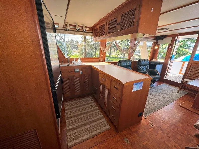 Slide: The Image of Interior of 1980 Ocean Alexander 50 MK1 yacht with wooden cabinetry and seating area. - 8
